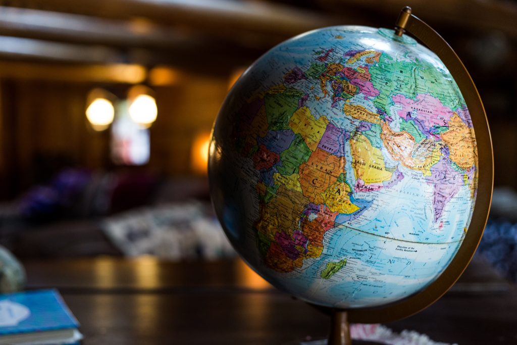Image of a globe sitting on a desk where foreign nationals discuss purchasing american real estate