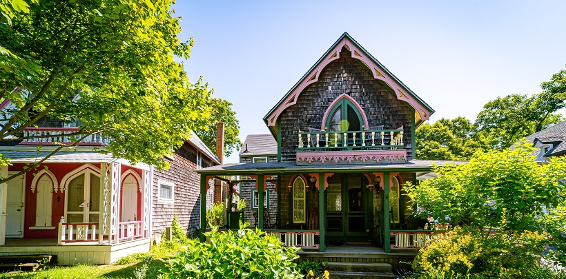 Image of the outside of a very colorful, ornately decorated house in Massachusetts. Captioned: A Quitclaim Deed In Massachusetts, No Problem.