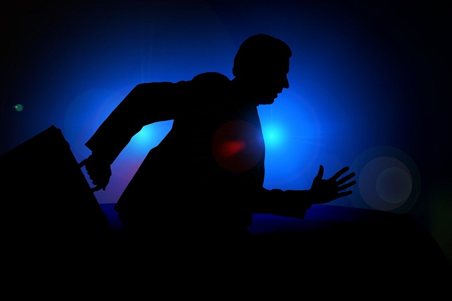 Silhouette of a person running with a briefcase. Captioned: Real Estate Law Enforcement Catching Up to Deed Fraudsters