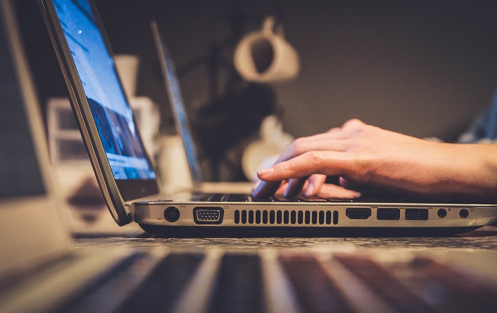 Image of a person using a laptop computer on a desk. Captioned: An update from Deeds.com on the fast-moving evolution of remote online notarization.