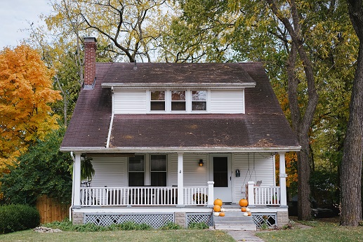 Image of a house with trees around it in the fall. Captioned: When a Home’s Past Holds an Unrecorded Deed