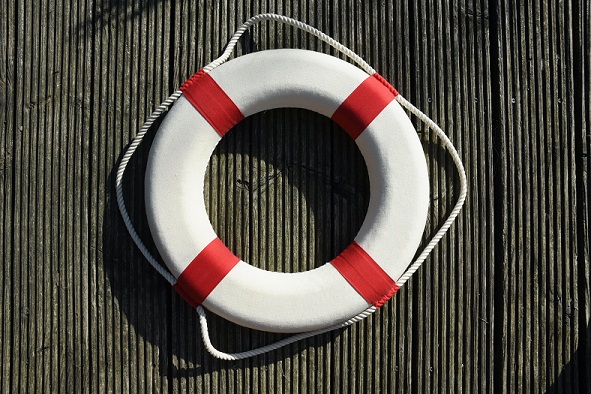 Image of a life preserver laying on a wood floor. Captioned: Chapter 13 was formulated to help people shield their valuables from liquidation and get a fresh start.