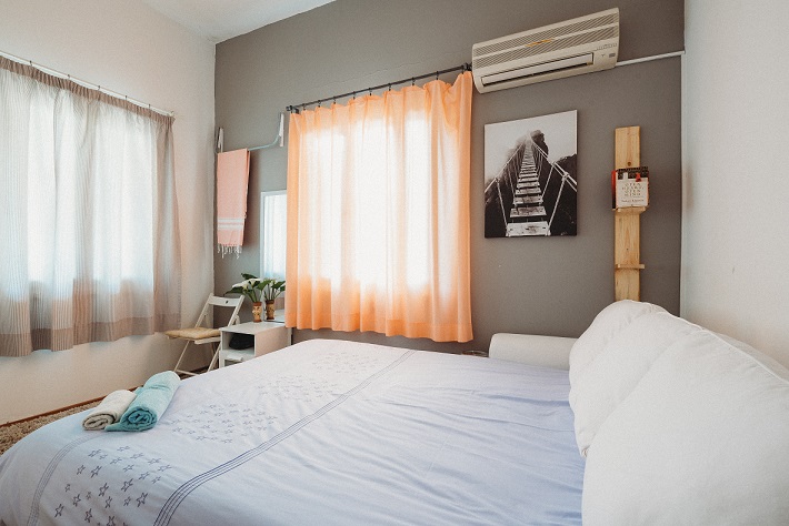 Image of a small bedroom. Captioned: Airbnb: Why It’s Hot, How It Works