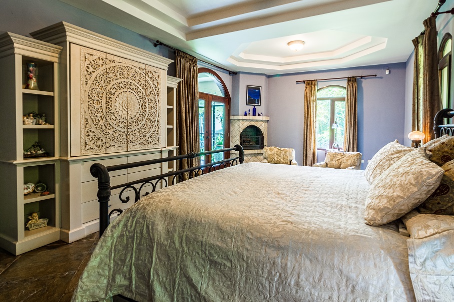 Image of a well appointed bedroom in what is likely a fancy house. Captioned: Real Estate Tax Changes Could Be Coming: Spotlight on Capital Gains and the Stepped-Up Cost Basis