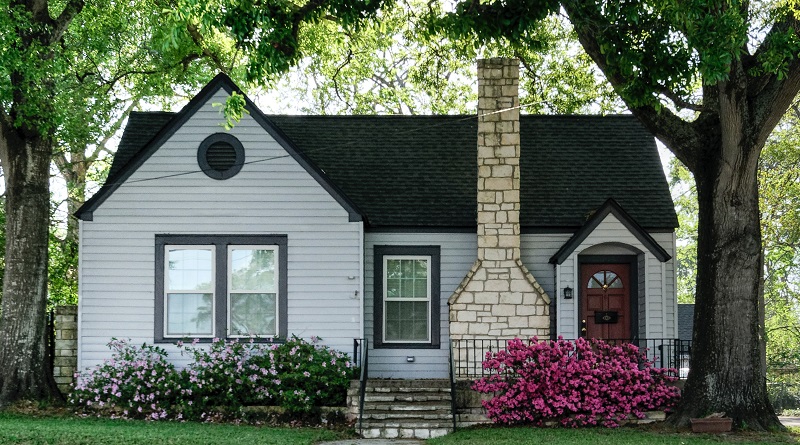 Image of a small, old house with a nice chimney. Captioned: Guide to Selling an Inherited Home