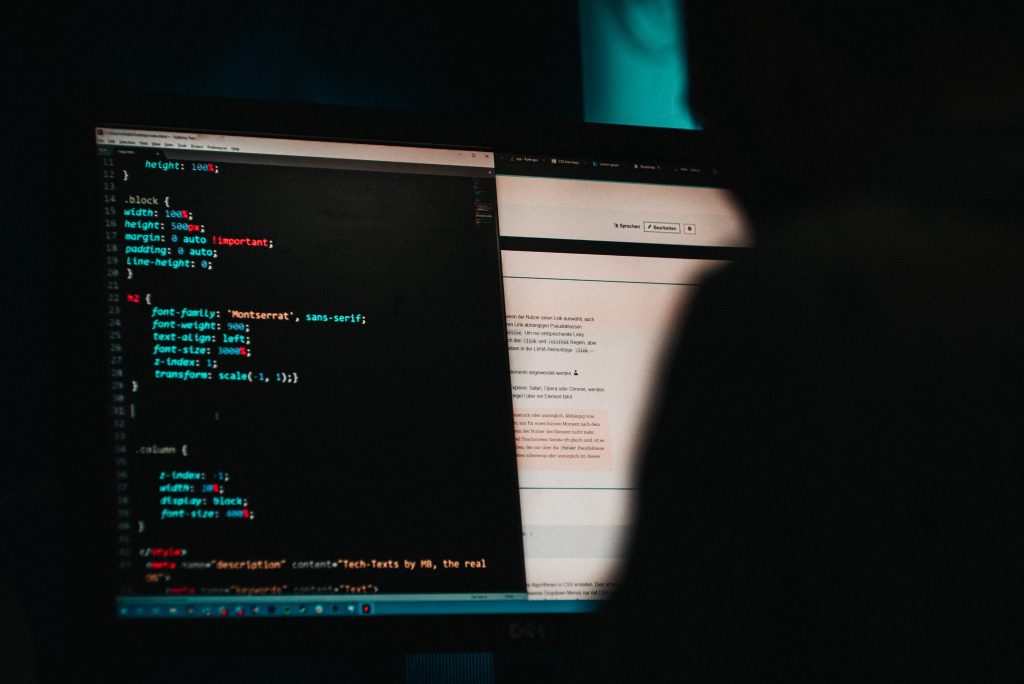 Imager of a shadowy figure in front of a computer screen with programing code on it. Captioned: Know the Signs. Prevent Identity Fraud.