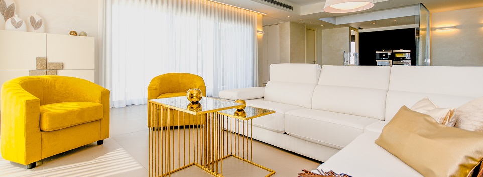 Image of a living room, well appointed with fancy furniture. Captioned: The “House Hacking” Trend: When a House Is a Rental Property Too