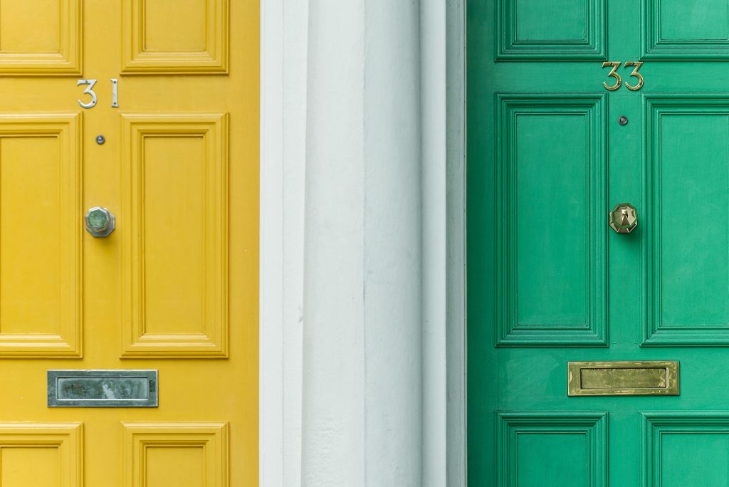 Image of two colorful doors on a house.