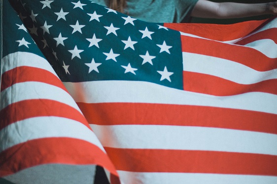 Image of the great flag of the United States of America. Captioned: Buying a Home With a VA Loan