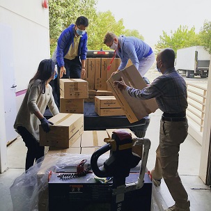 Image of people loading boxes on to a truck.