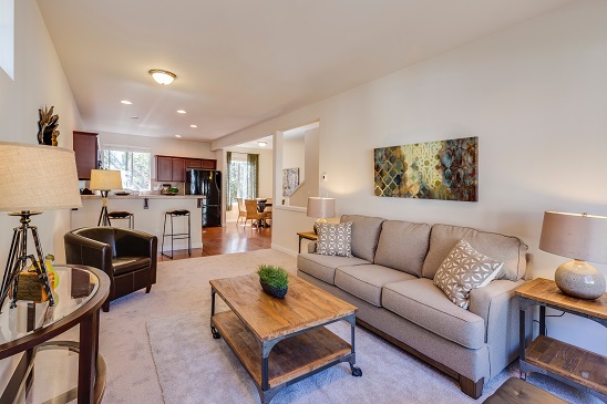 Image of the inside of a furnished house. Captioned: The Benefits and Risks of the 1031 Exchange.