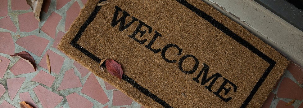Close up image of a welcome mat on a house doorstep. Captioned: Race Restrictions Still Appear on Deeds. There’s a Movement Afoot to Delete Them.