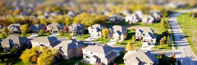 Aerial view of a suburban housing neighborhood. Captioned: Real Estate Legal Descriptions for Deeds