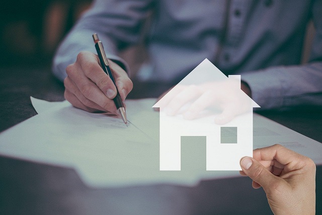 Image of a person signing documents. Captioned: Mortgage Approvals: The New Landscape for Post-Pandemic Home Buyers