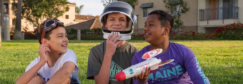 Image of three kids pretending to be space explorers. Captioned: Extraterrestrial Real Estate, Is a Lunar Deed Legit?