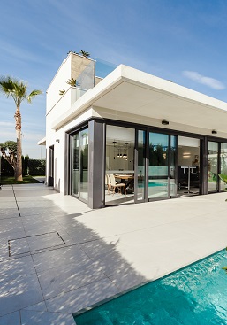 Outside corner of a house looking over a pool. Captioned: Transforming the Investor Experience.