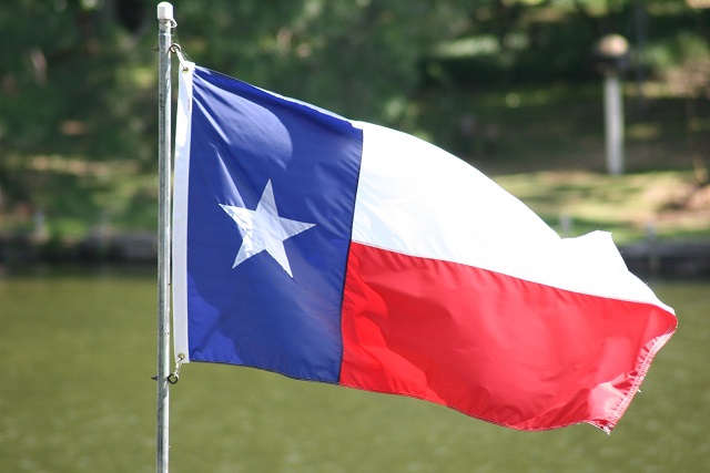 Texas Flag, outside blowing in the wind.