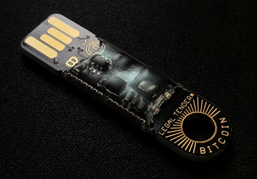 Image of a flash drive with cryptocoin terminology printed on it.