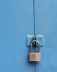 Image of a padlock securing a wooden structure.