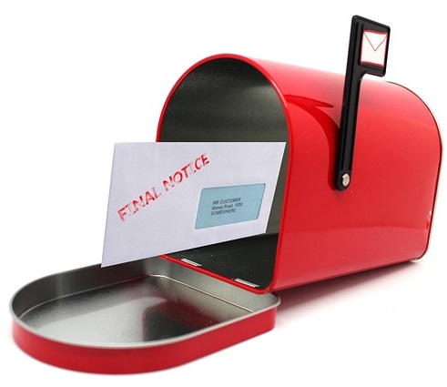 Image of an open mail box with an eviction notice letter in it.