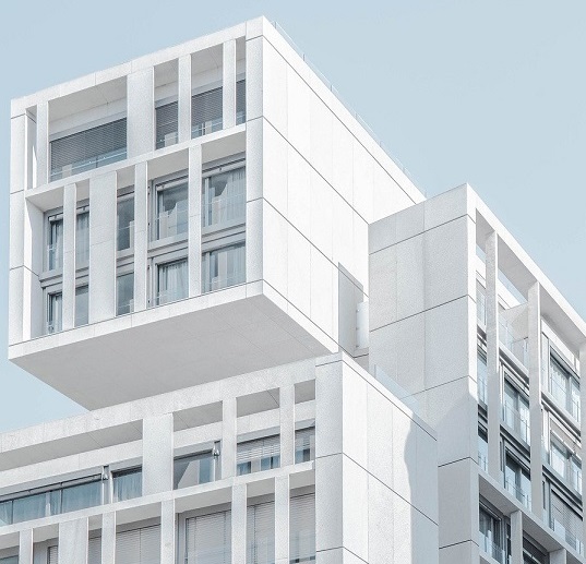Image of a modern looking modular building. Captioned: Blockchain and the Mortgage Loan