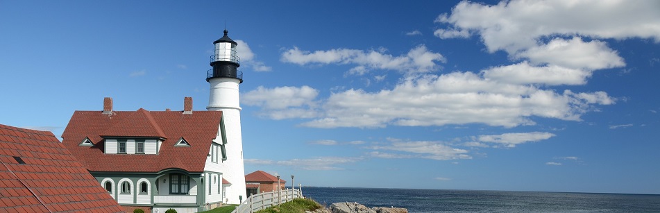 Image of a lighthouse on a large body of water in Maine.