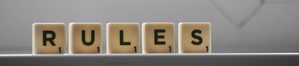 Letter tiles lined up to spell "RULES" captioned: Here Come the Rules and Taxes