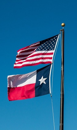 Image of the American Flag and the Texas Flag.