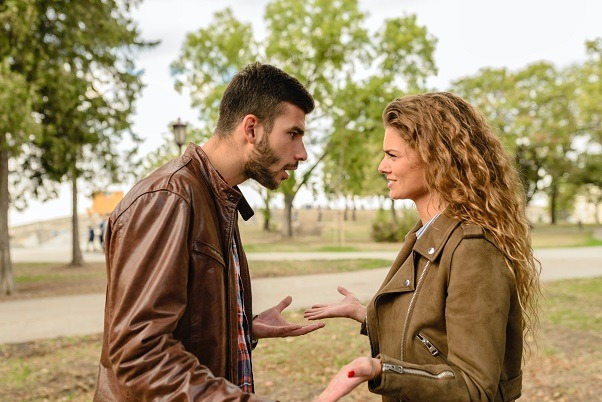 Two people arguing over their real estate boundary line.
