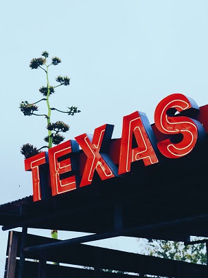 A neon signs that reads: Texas in big red letters.