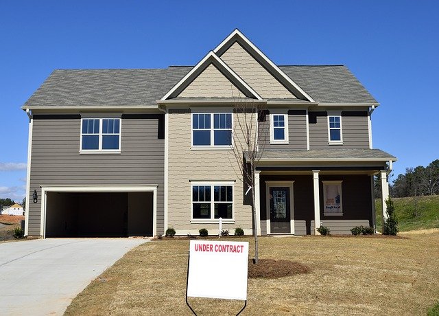 Image of a house with a sign in front that reads: "Under Contract"