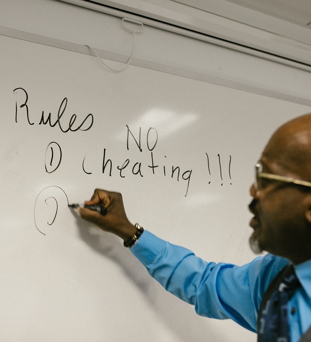 Person writing on a whiteboard.