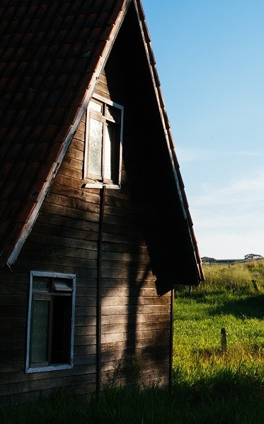 Image of an old family home in a beautiful open setting