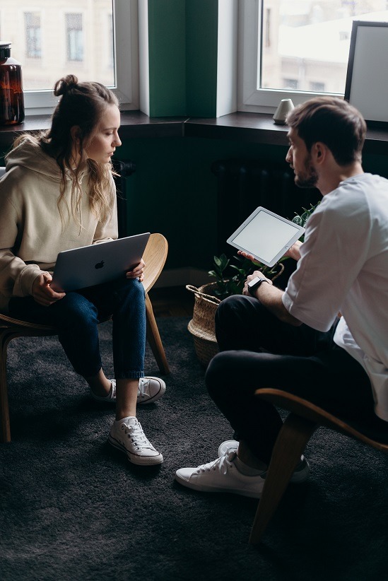 Two people in a house discussing how to market a renovated house.