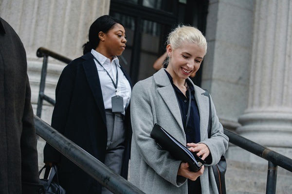 Two people walking out of a courthouse after milestone legislation is passed