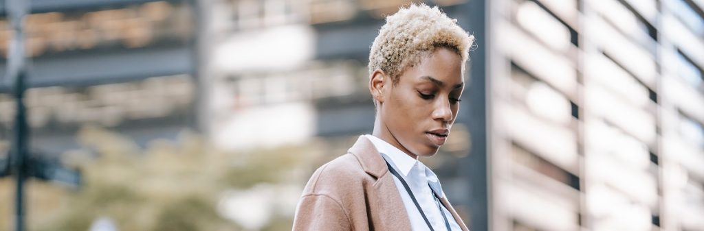 A person outside contemplating why bias in real estate lending still exists.