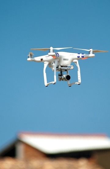 image of a drone flying about houses