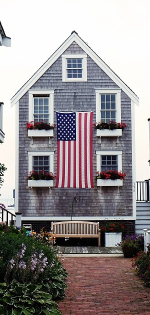 Image of the outside of a condo with an American Flag draping from the side