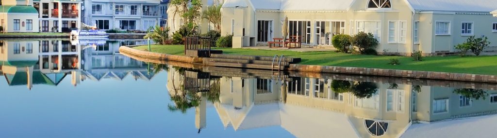 Image of houses near water showing their reflection much like an image in the metaverse.