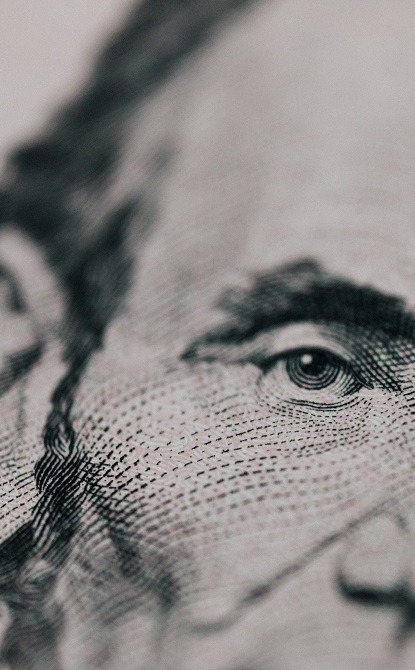 Close up image of Lincoln's picture on the five dollar bill.