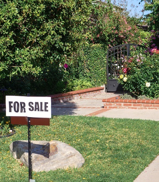 Image of a for sale sign out side of a house