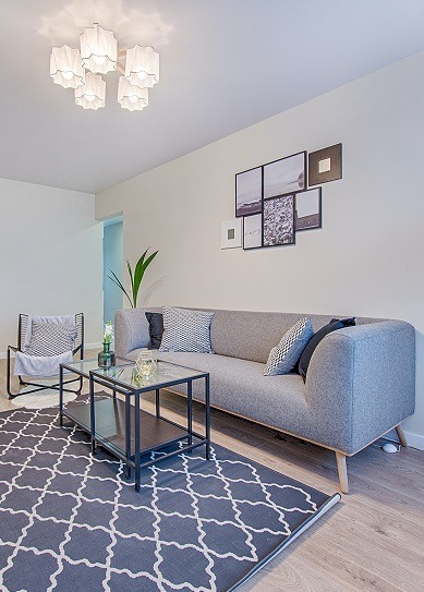 Image of a modestly appointed living room inside a house.